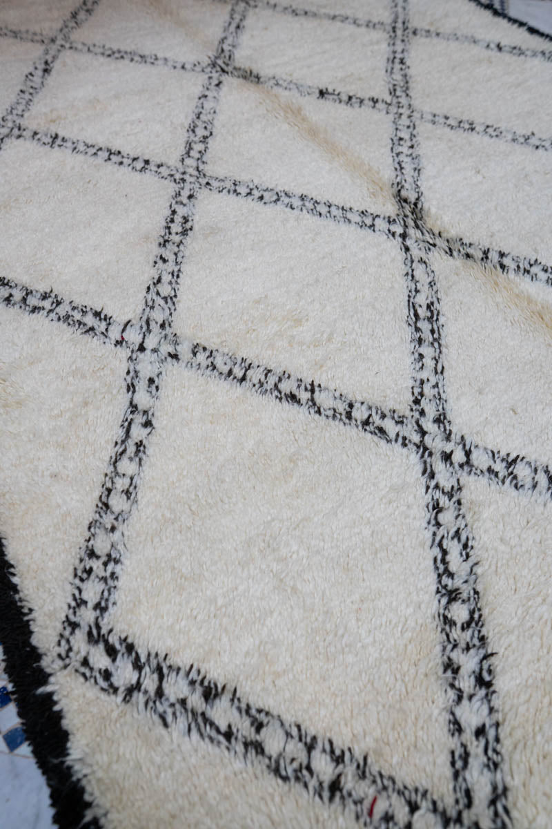 Close-up of a textured white and black checkered Moroccan Rug