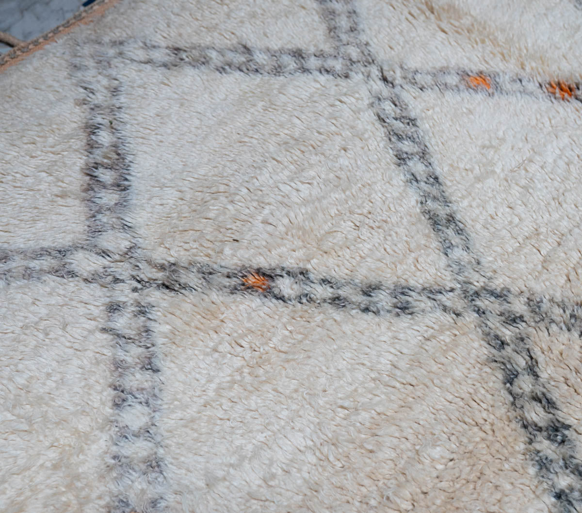 Close-up of a textured rug with geometric pattern