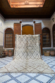Moroccan-style room with a large Moroccan Beni Ouarain Vintage rug on a checkered floor