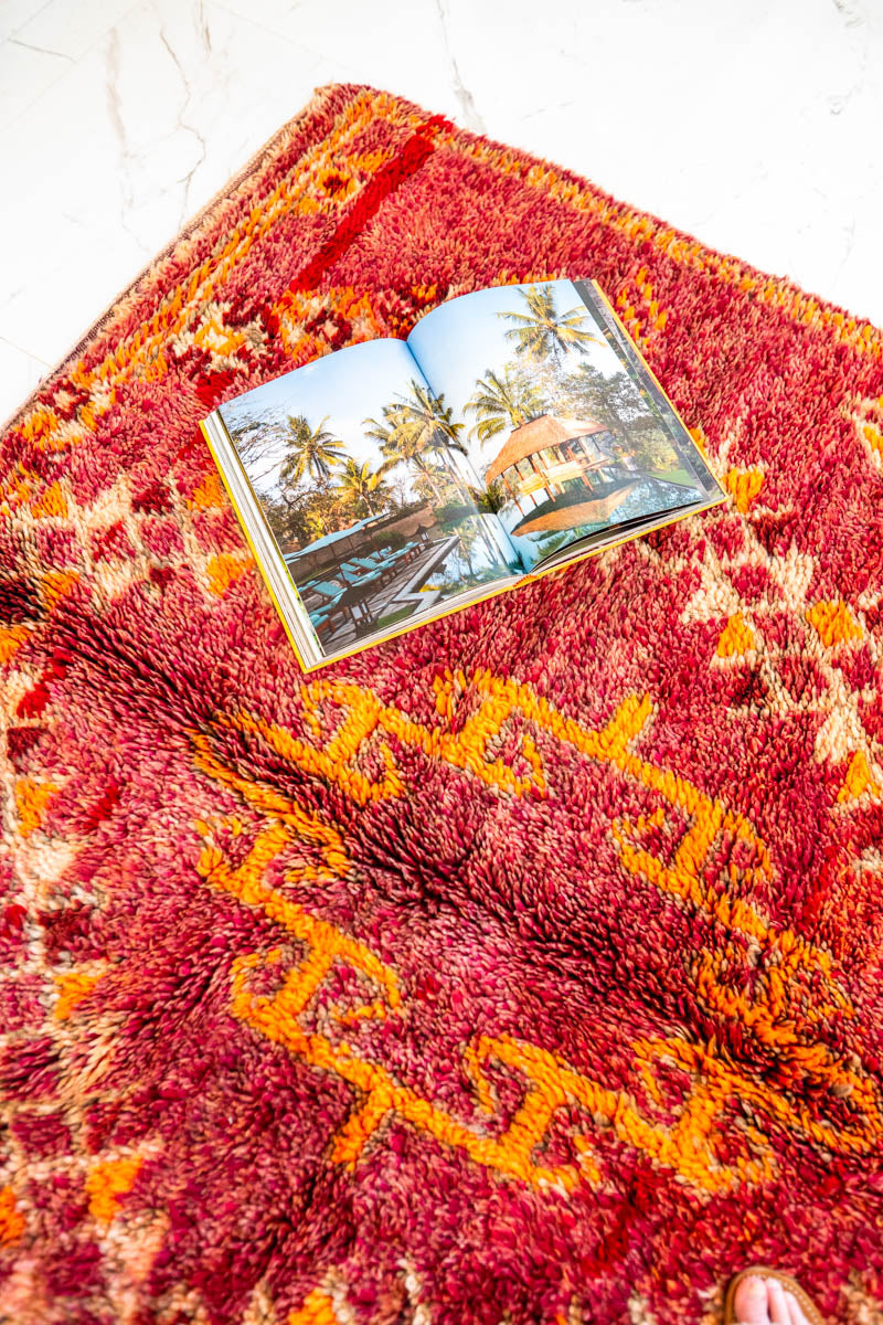 Marokkolaisen vintage-maton päällä kirjan aukeamassa Marrakech-maisema