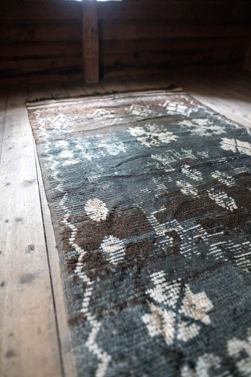 Vintage-style rug with intricate patterns on a wooden floor